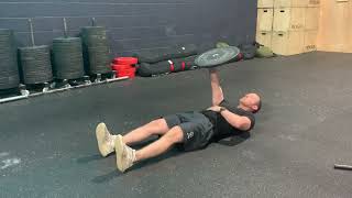 Single arm overhead plate sit up demonstration